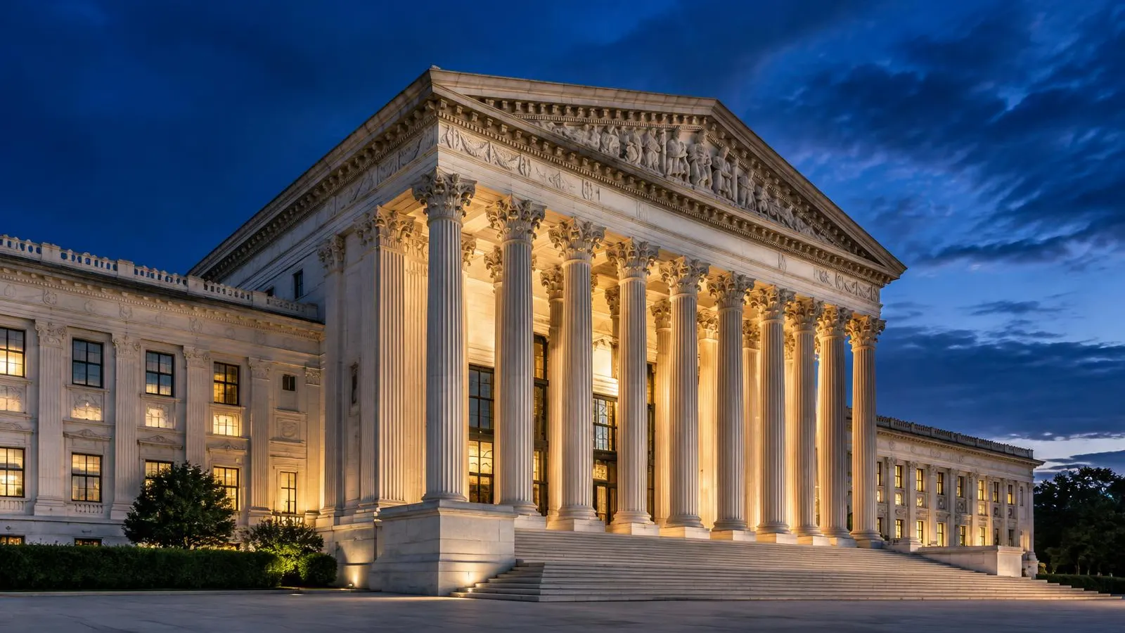 Classical columned government building lit at dusk